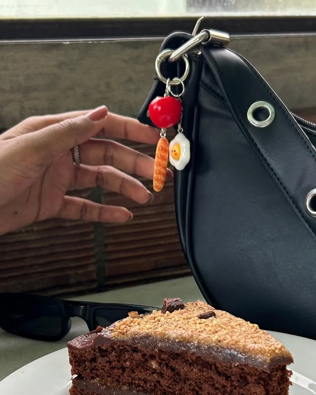 Citrus charm clipped to a black bag